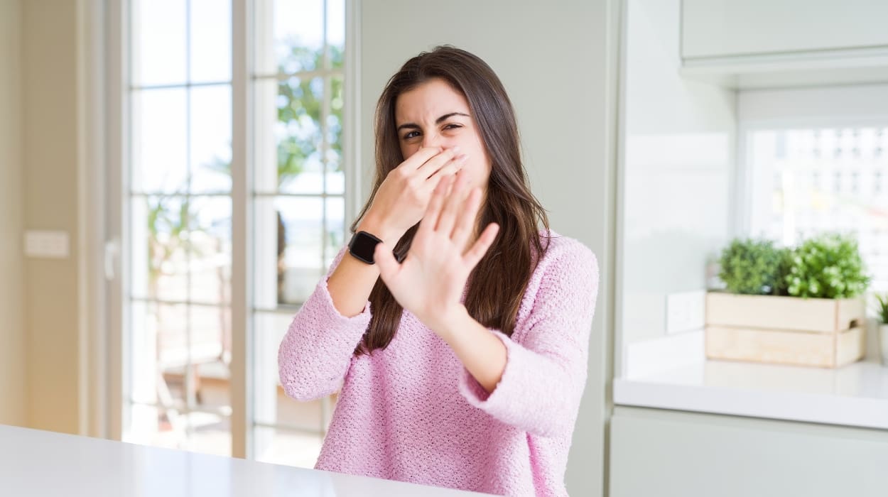 A woman is repulsed by her smelly house